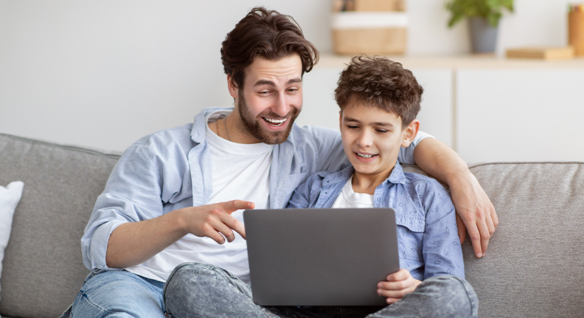 Father Helping Son With Computer